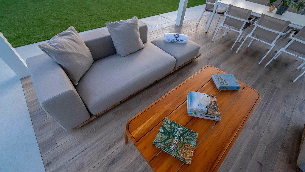 Villa landscape design and build in Dubai with a swimming pool, water spouts, in-water loungers, lawn and shaded pergola lounge