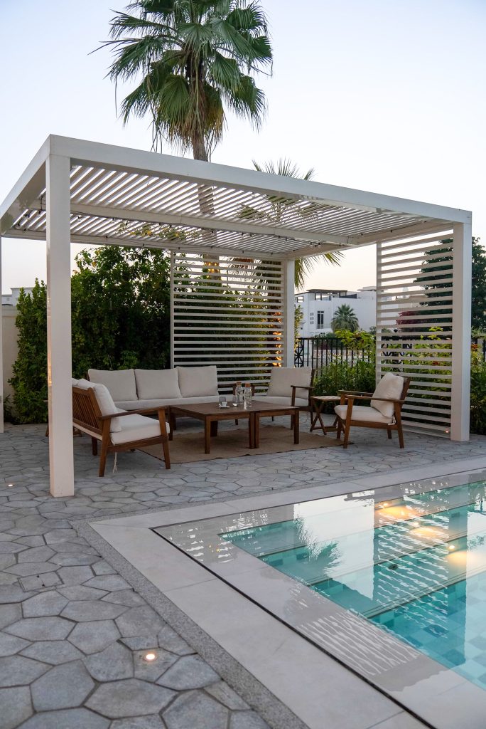 Luxury villa landscape design and build in Emirates Hills, Dubai with a swimming pool, tropical garden planting and shaded outdoor living areas