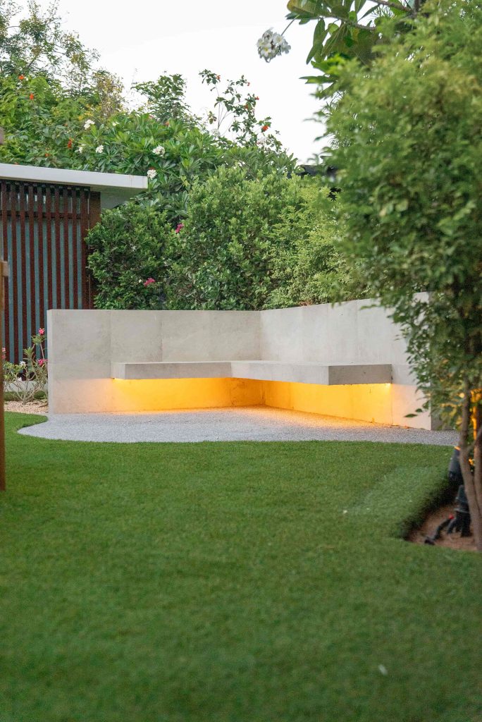 Villa landscape design and build in The Meadows, Dubai with a swimming pool, shaded poolside seating, built-in bench and garden lighting