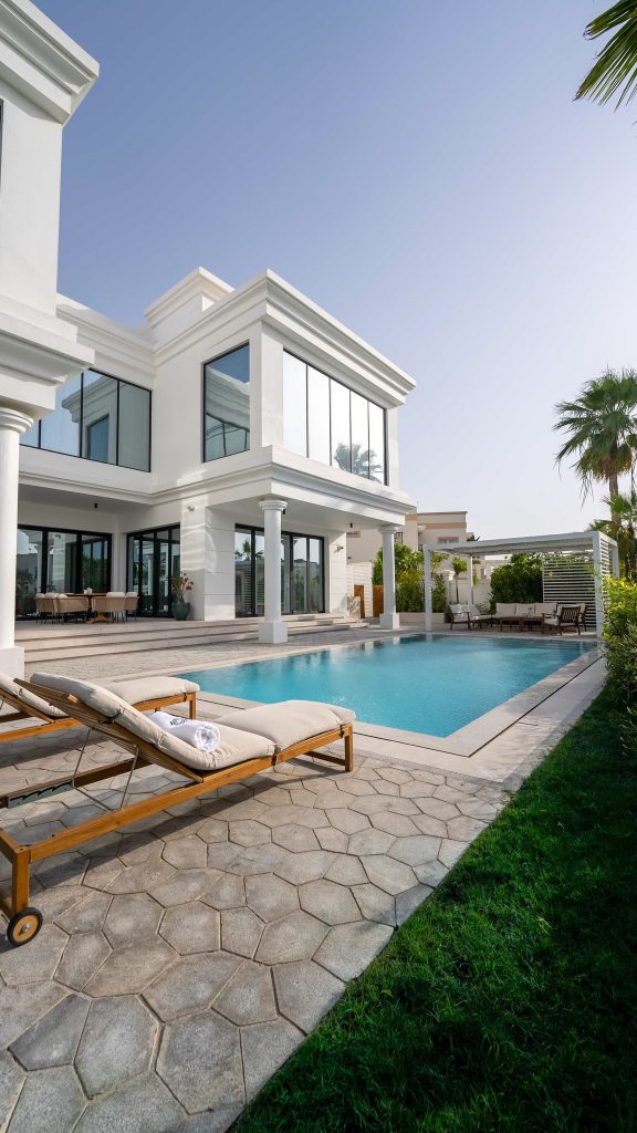 Luxury villa landscape design and build in Emirates Hills, Dubai with a swimming pool, tropical garden planting and shaded outdoor living areas