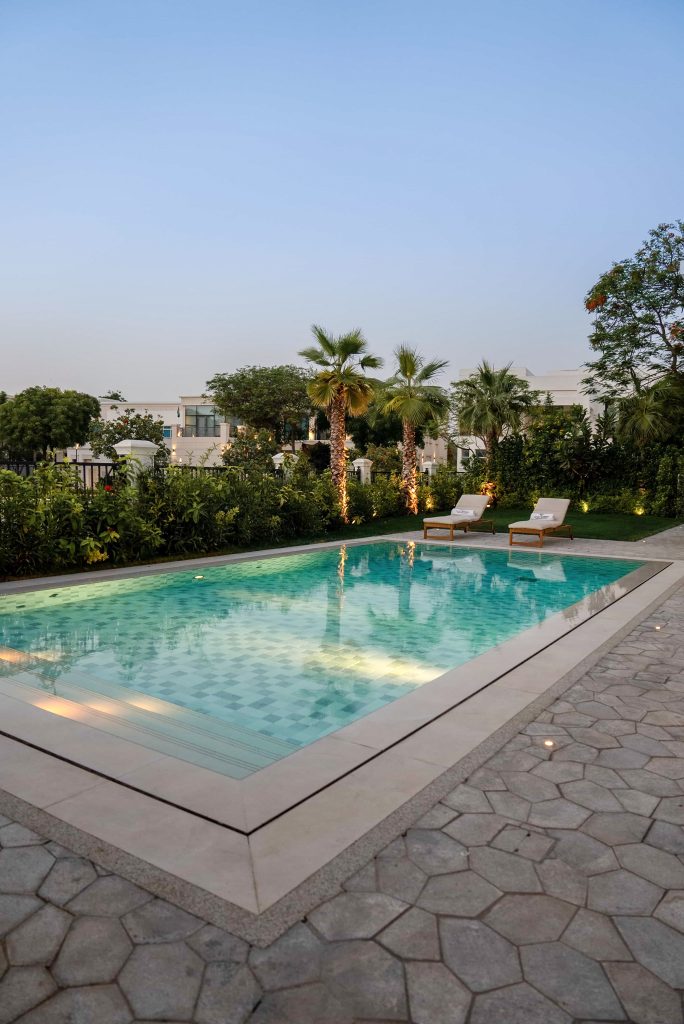 Luxury villa landscape design and build in Emirates Hills, Dubai with a swimming pool, tropical garden planting and shaded outdoor living areas