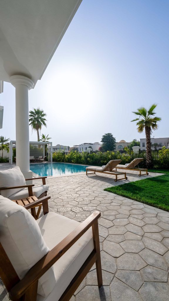 Luxury villa landscape design and build in Emirates Hills, Dubai with a swimming pool, tropical garden planting and shaded outdoor living areas