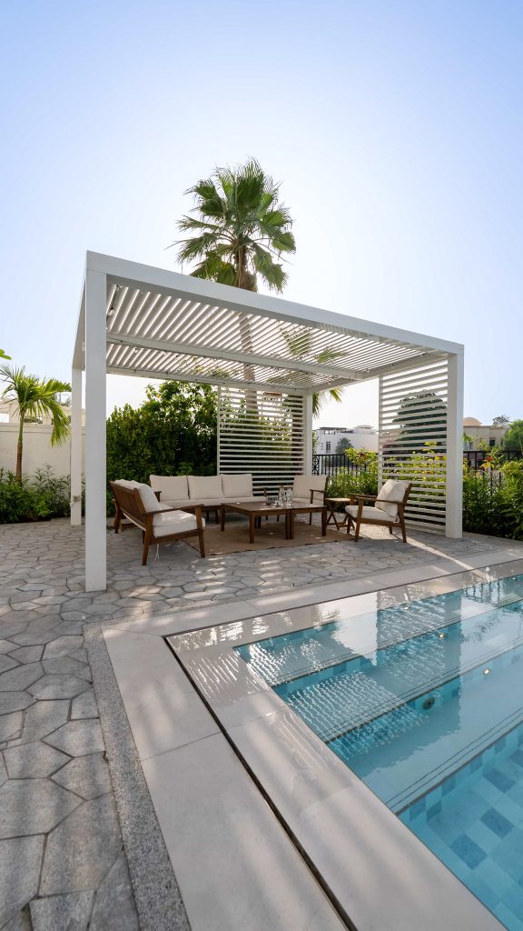 Luxury villa landscape design and build in Emirates Hills, Dubai with a swimming pool, tropical garden planting and shaded outdoor living areas