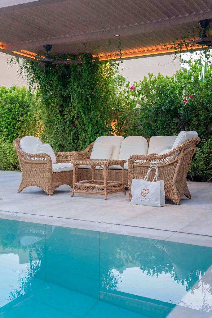 Villa landscape design and build in The Meadows, Dubai with a swimming pool, shaded poolside seating, built-in bench and garden lighting