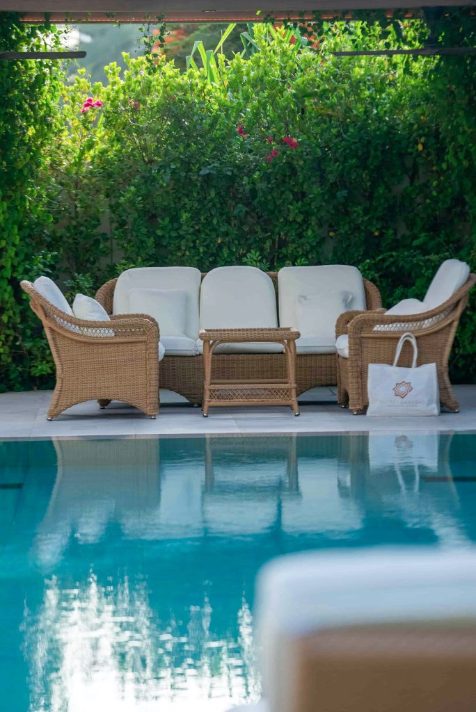 Villa landscape design and build in The Meadows, Dubai with a swimming pool, shaded poolside seating, built-in bench and garden lighting