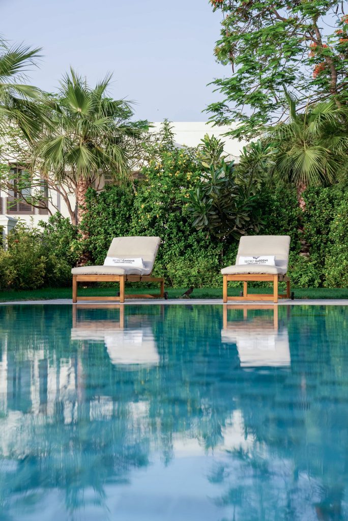 Luxury villa landscape design and build in Emirates Hills, Dubai with a swimming pool, tropical garden planting and shaded outdoor living areas